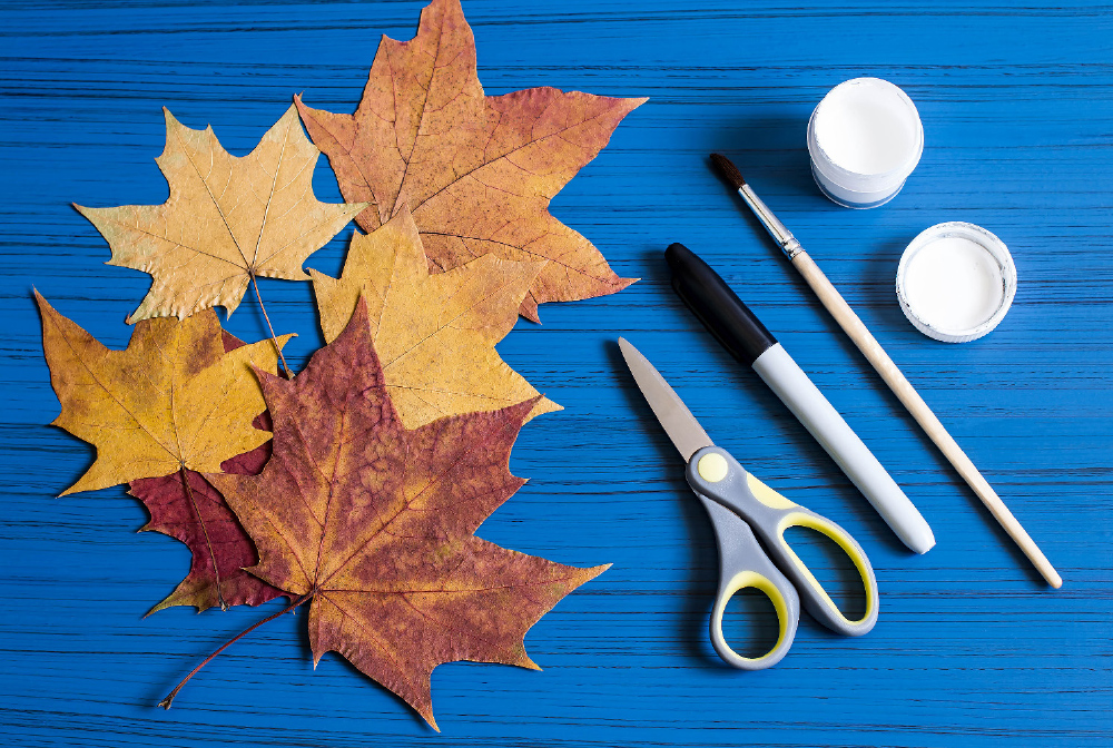 Collect fall leaves in different sizes. You will also need scissors, a marker, a paintbrush and white paint.