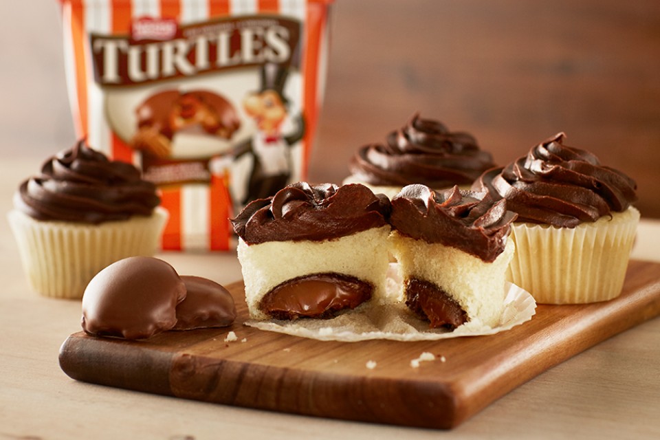 TURTLES Hidden Gem Cupcakes Recipe. Whole TURTLES baked into fluffy cake, these delicious treats are sure to surprise and delight.